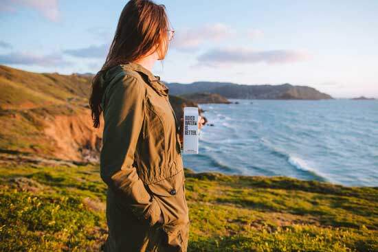 A woman along a seashore, contemplating how she can be a good steward of the earth