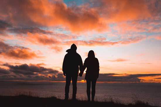 A husband and wife holding hands and reflecting God's image