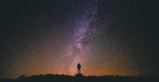 Silhouette of a man gazing at stars as we learn about God who revealed His character of love and grace to Moses. 