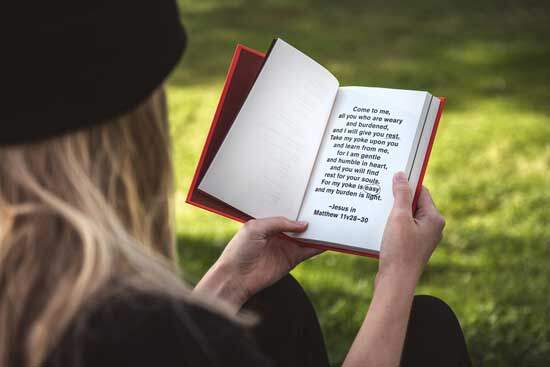 Girl reading Jesus' promise in Matthew 11:28 "Come unto me, all you that labour & are heavy laden, & I will give you rest"