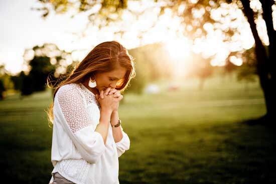 Woman in white, claiming in faith the righteousness of God as described in Romand 3:21 as the Holy Spirit points her to Jesus