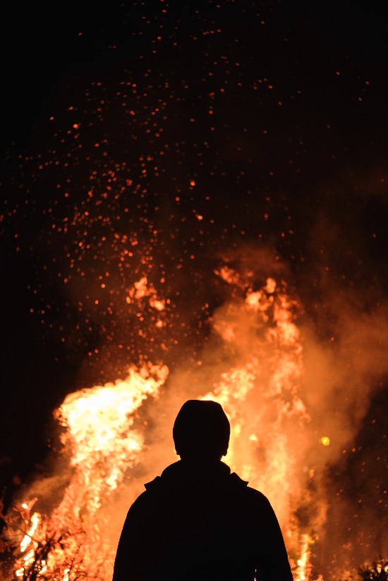 Silhouette of a man standing before a burning bush as we study call of Moses to lead God's people out of Egyptian slavery.