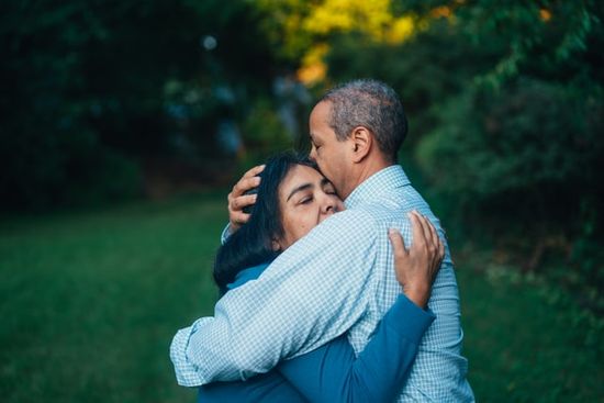 A couple hugging each other in forgiveness