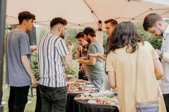 People in line to get food at an Adventist potluck