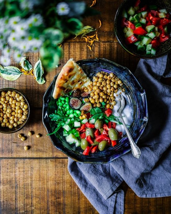 A plate of vegetarian food with legumes and vegetables