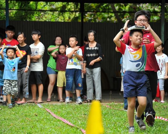 Children from an adventurer club playing games at a camporee