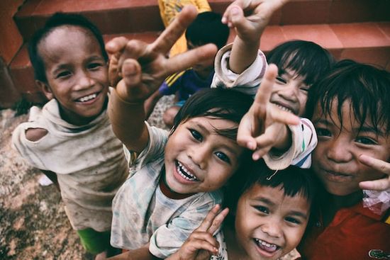 A group of smiling Vietnamese children who have been impacted by the evangelism projects of ASI