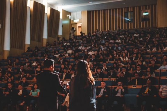 A couple speaking at a convention center for an evangelistic series