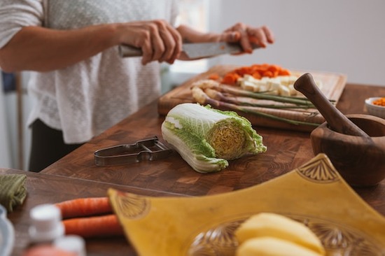 A woman chops vegetables for a meal after deciding to give up meat eating