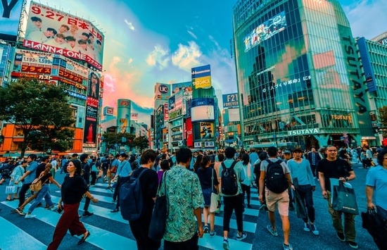 A busy city intersection with a crowd of people, all people to whom the salvation of Jesus Christ is available