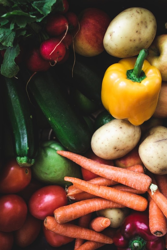 All kinds of veggies, including carrots, bell pepper, zucchini, potatoes, and radishes