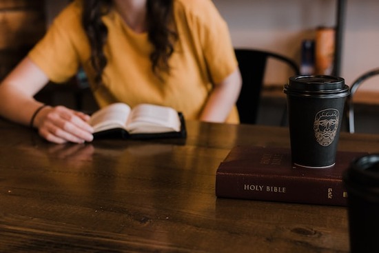  A woman reading her Bible and Ellen White's writings