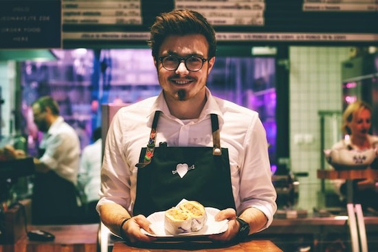 A man serving food at a restaurant with the Bible as his guide for every aspect of the Christian life