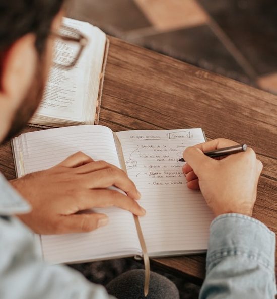 A man taking notes from observations he's made in God's Word