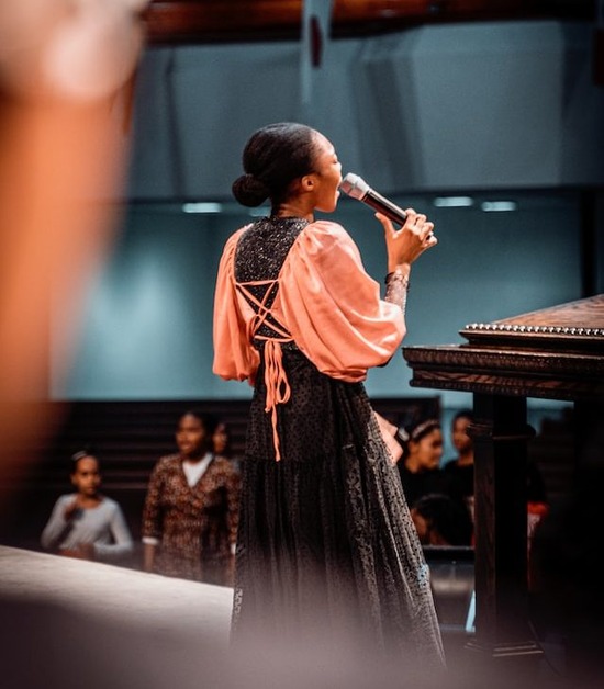 Woman leading the singing of hymns at the front of her church 